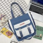 Multiposition canvas bag with front buckles belt