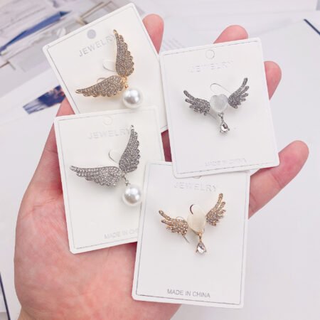 Angel's wing shaped brooches