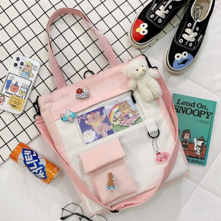 Multiposition canvas shoulder bag with cartoon and front pocket